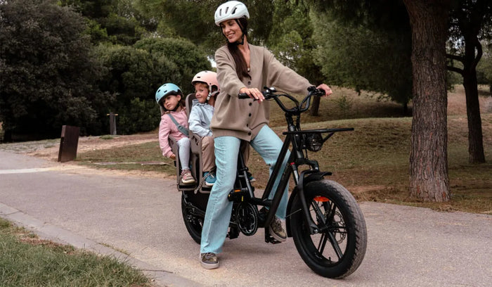 Eine Frau fährt ein Fiido T2 Lasten-Elektrofahrrad und transportiert ihr Kind.